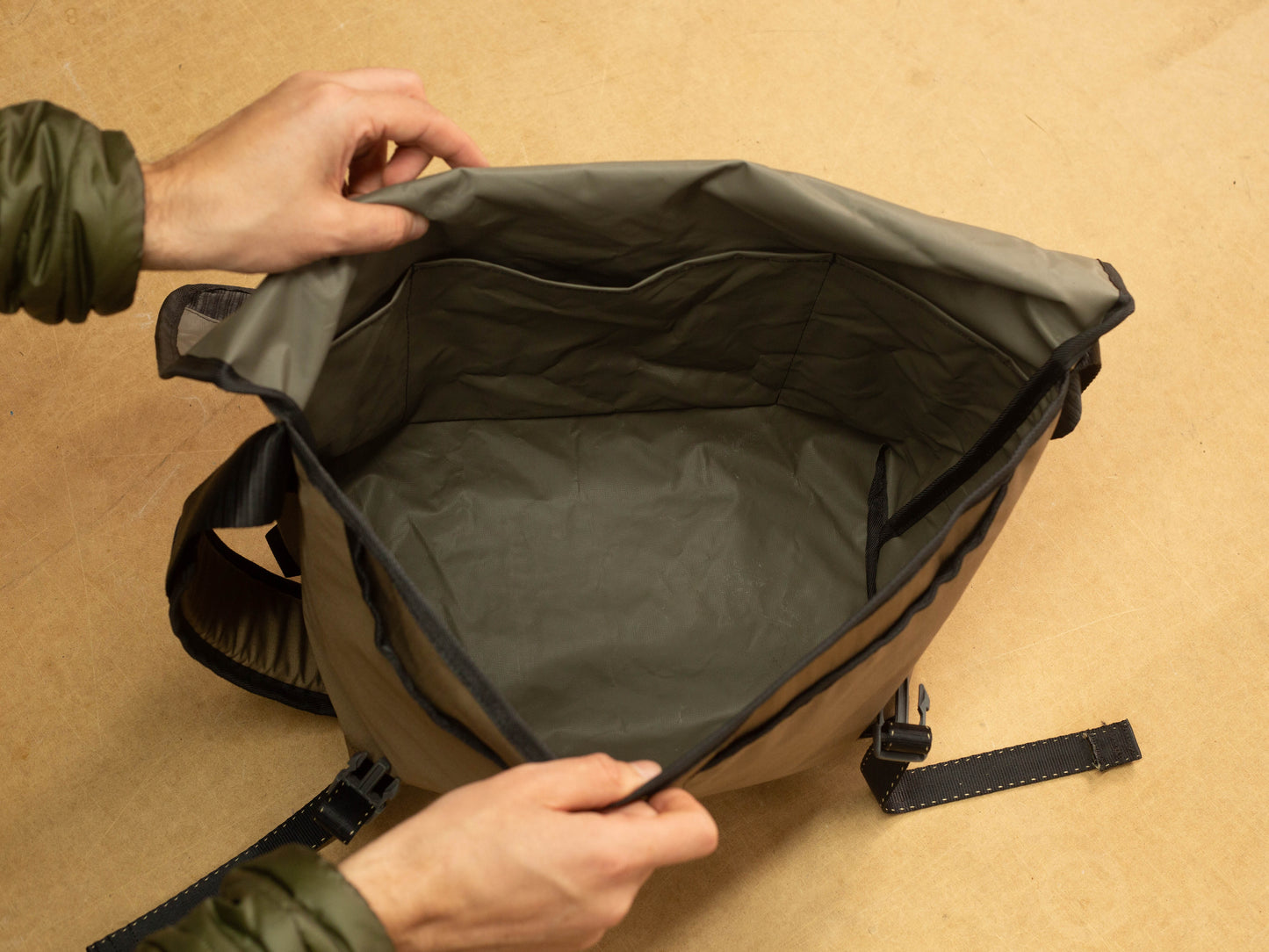 Open wipwrk mondo messenger bag interior revealing a spacious main compartment with water-resistant lining and integrated organizer pockets