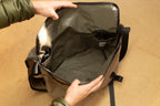 Open wipwrk Mondo Hauler messenger bag interior revealing a spacious main compartment with durable black water-resistant lining and integrated organizer pockets